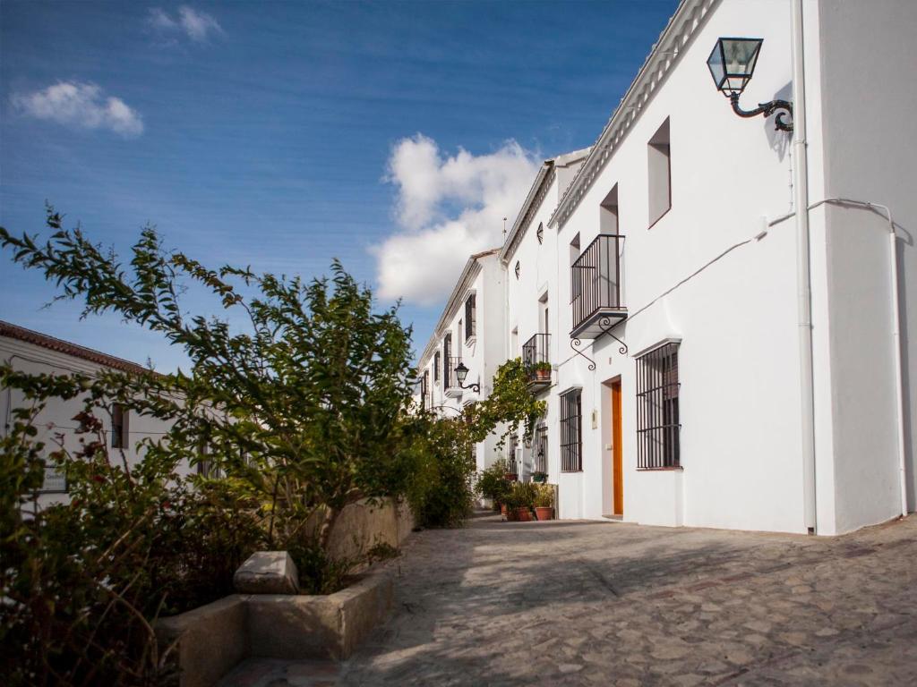 a street in a white building with a tree next to it at El Buen Sitio in Zahara de la Sierra