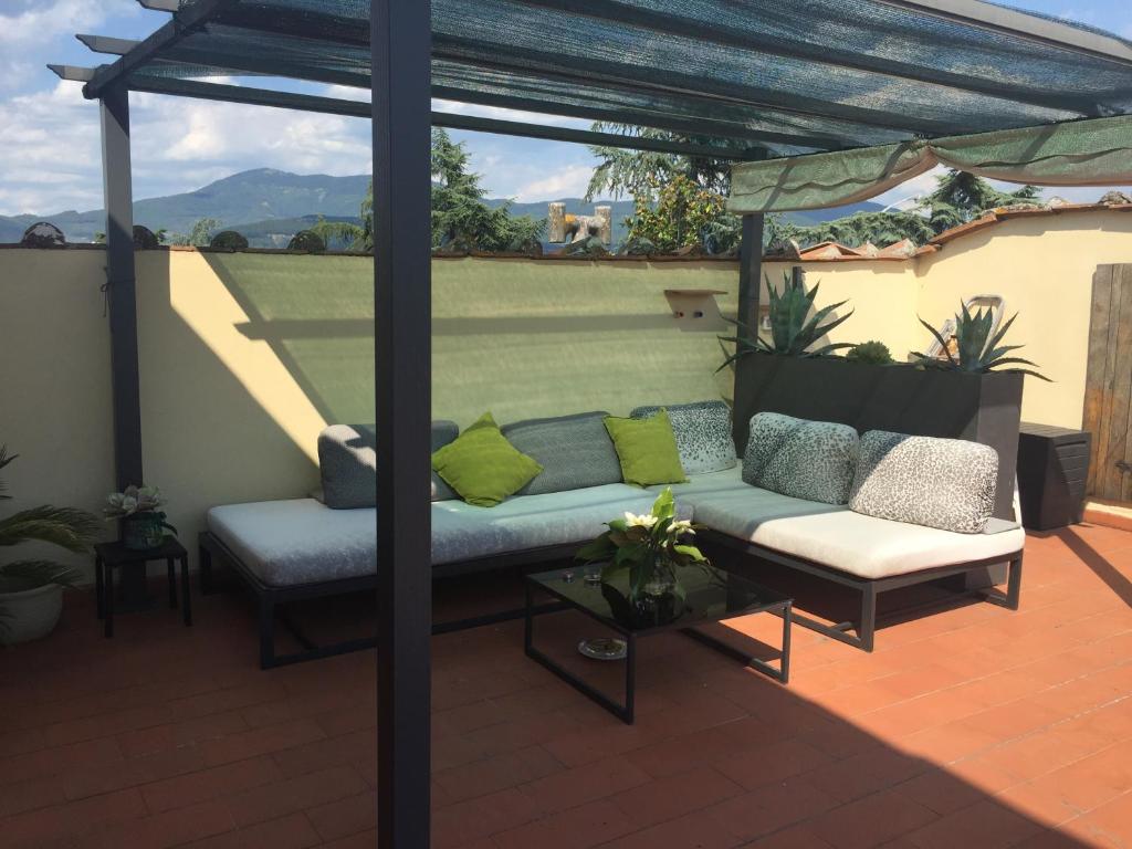 a pergola with a couch on a patio at Laura's in Sesto Fiorentino