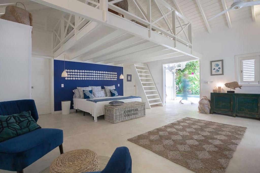 a large room with a bed and a staircase at Mahona Boutique Hotel in Las Terrenas
