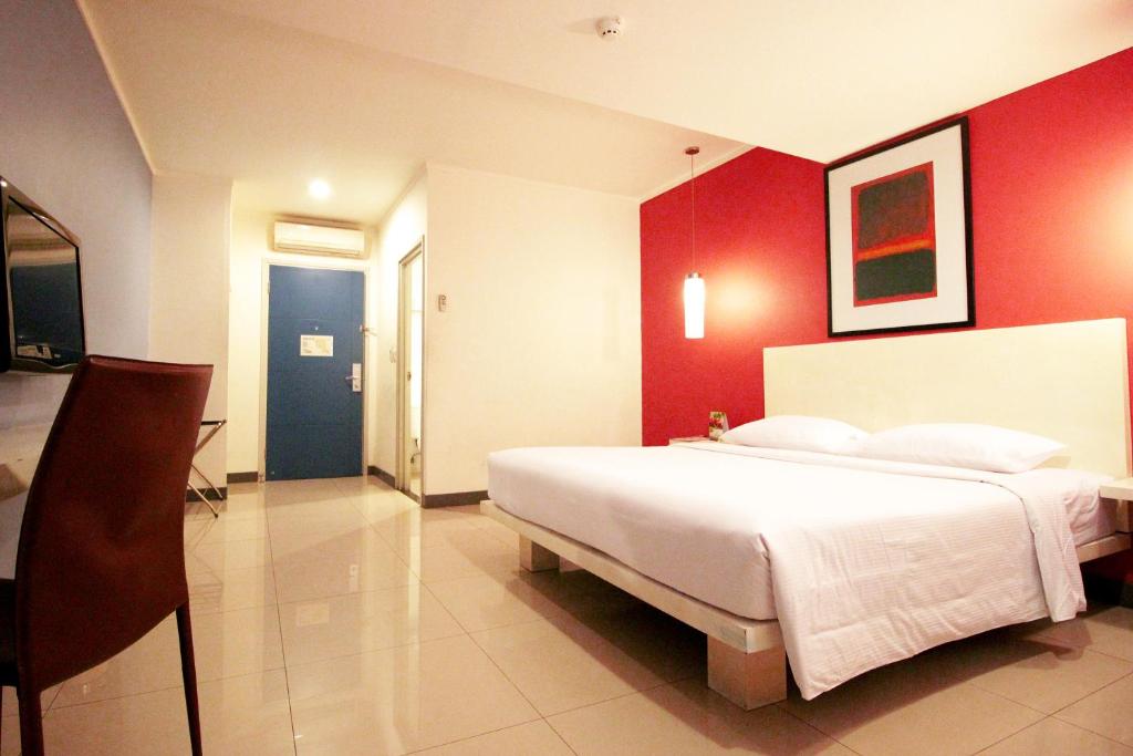 Postel nebo postele na pokoji v ubytování Hotel Glodok Plaza
