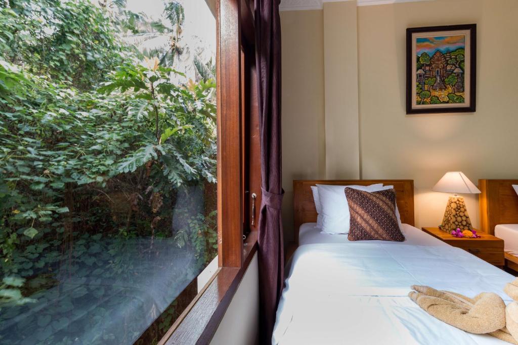 Postel nebo postele na pokoji v ubytování Alam Pangkung Ubud
