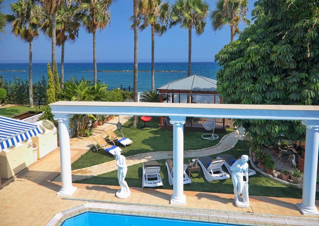 a view from the balcony of a resort with a swimming pool at Limassol Beachfront Holiday Villa in Limassol