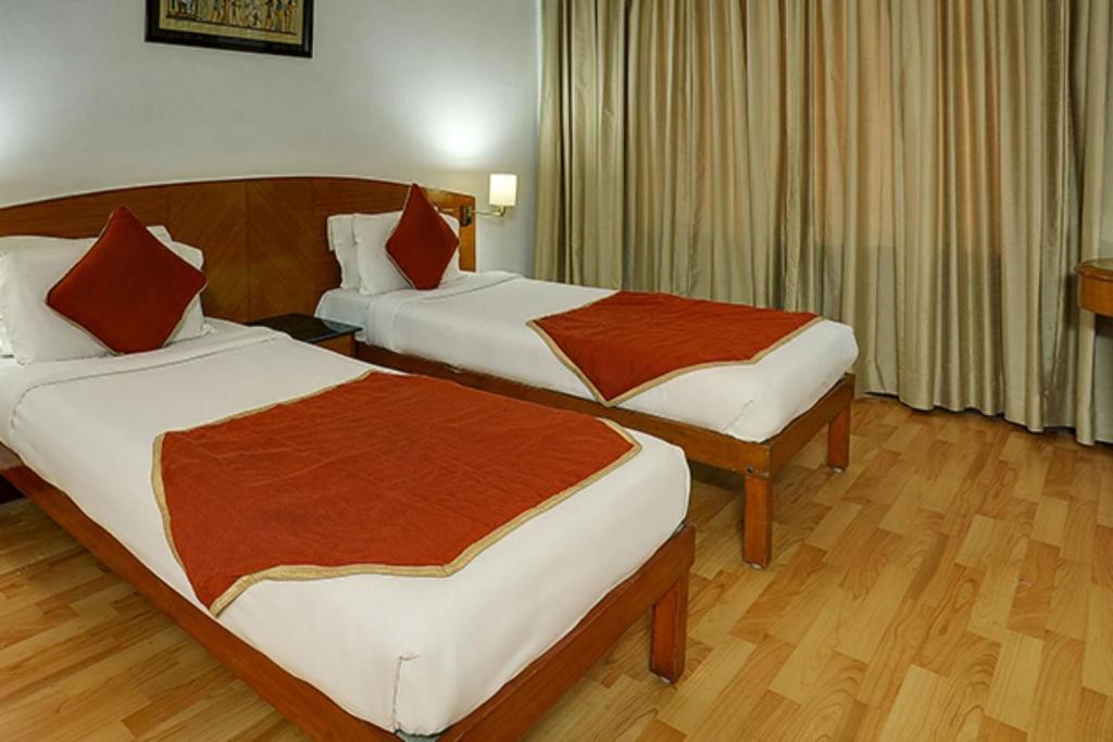Postel nebo postele na pokoji v ubytování Ramee Guestline Tirupati