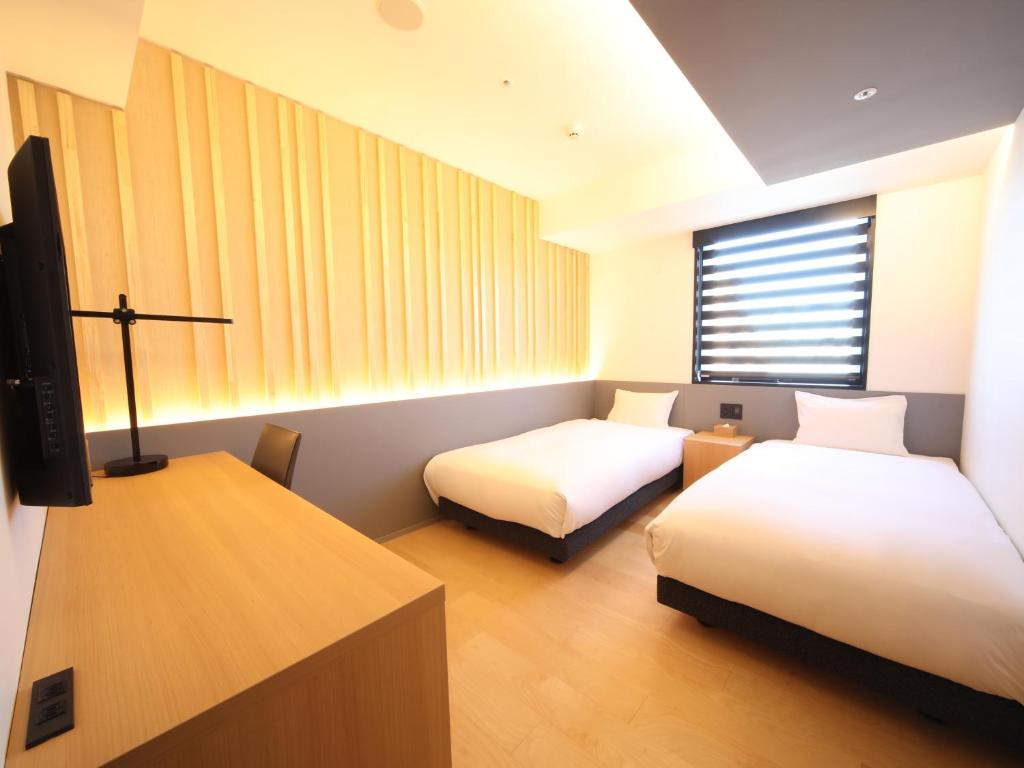 Postel nebo postele na pokoji v ubytování hotel androoms Nagoya Sakae