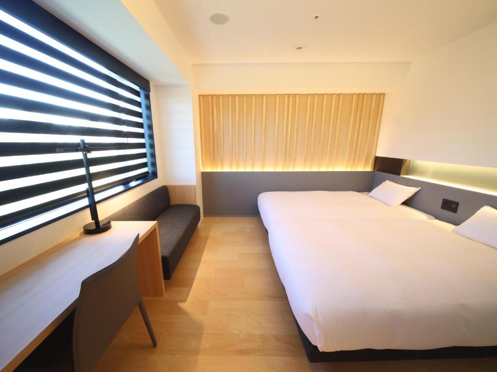 Postel nebo postele na pokoji v ubytování hotel androoms Nagoya Sakae