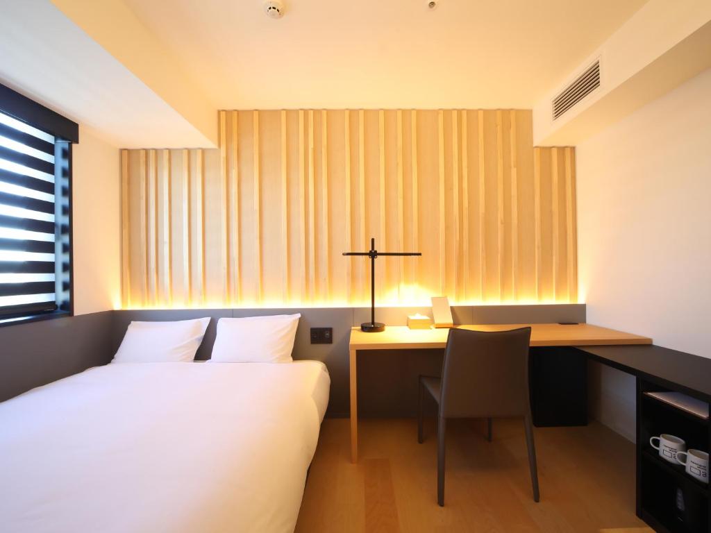 Postel nebo postele na pokoji v ubytování hotel androoms Nagoya Sakae