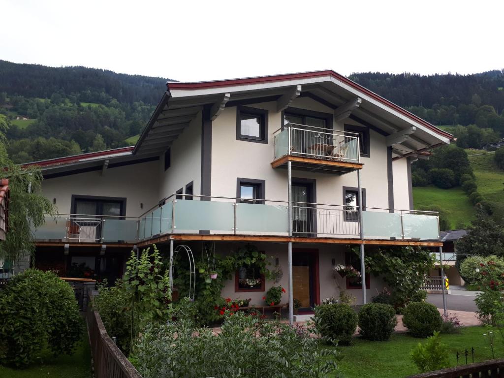 a house with balconies on a hill at Haus Lercher in Bramberg am Wildkogel
