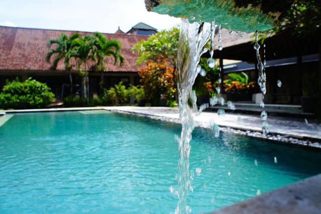 a water fountain in a swimming pool at Sayang Taman Villas in Sanur