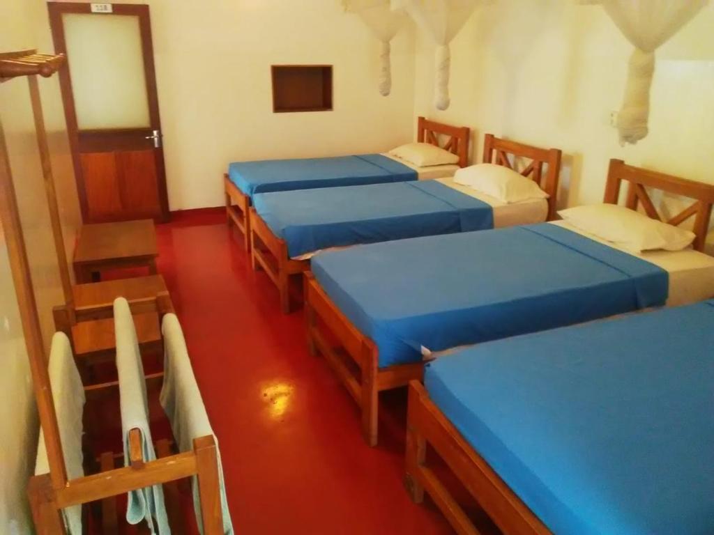 Postel nebo postele na pokoji v ubytování Hotel Mango Garden