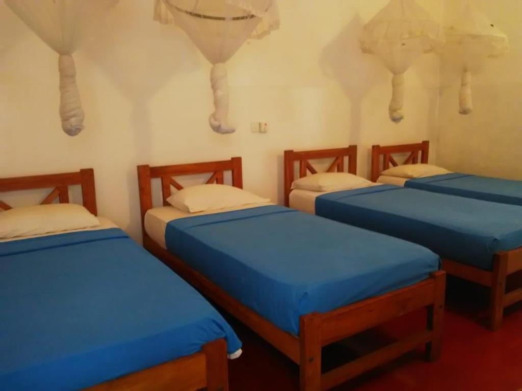 Postel nebo postele na pokoji v ubytování Hotel Mango Garden
