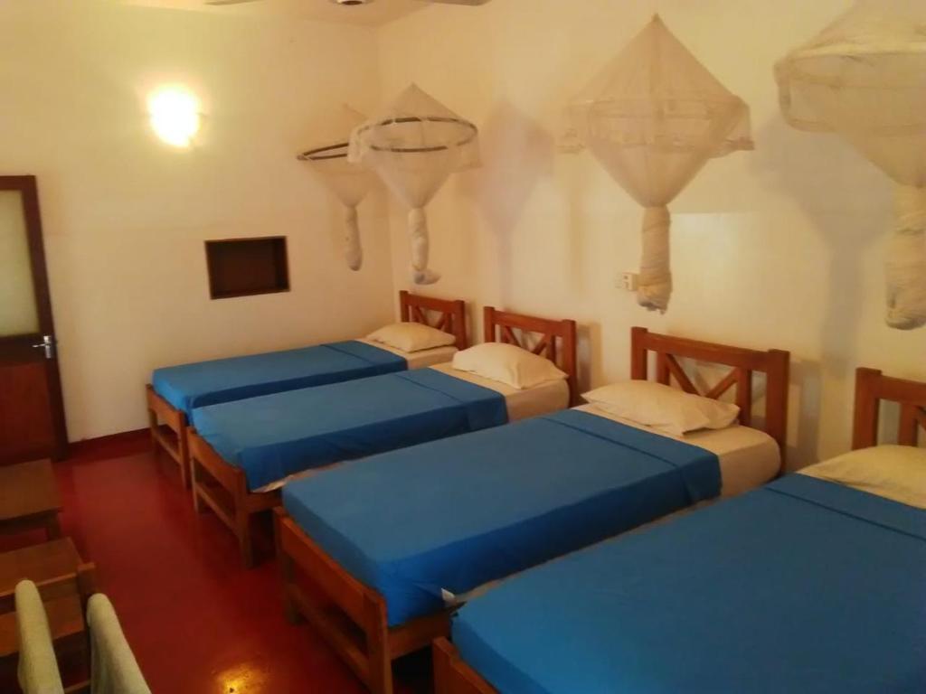 Postel nebo postele na pokoji v ubytování Hotel Mango Garden
