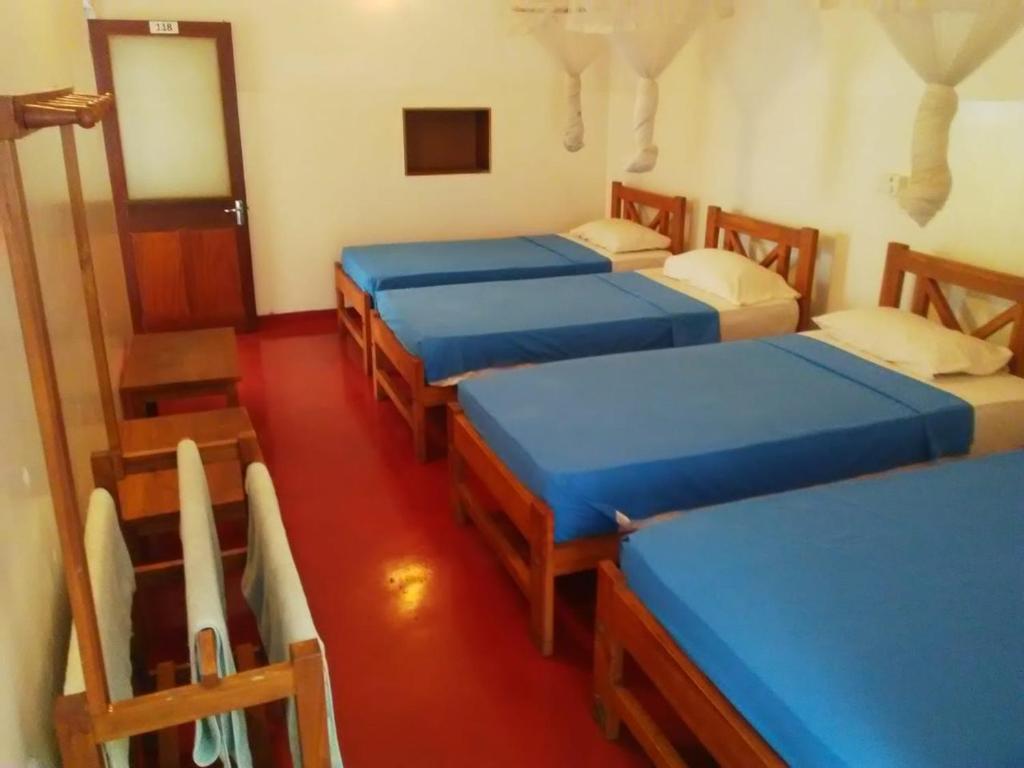 Postel nebo postele na pokoji v ubytování Hotel Mango Garden