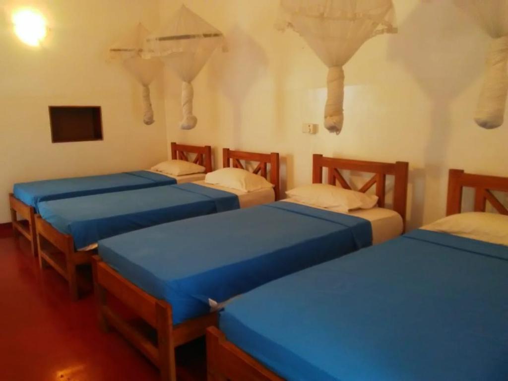 Postel nebo postele na pokoji v ubytování Hotel Mango Garden