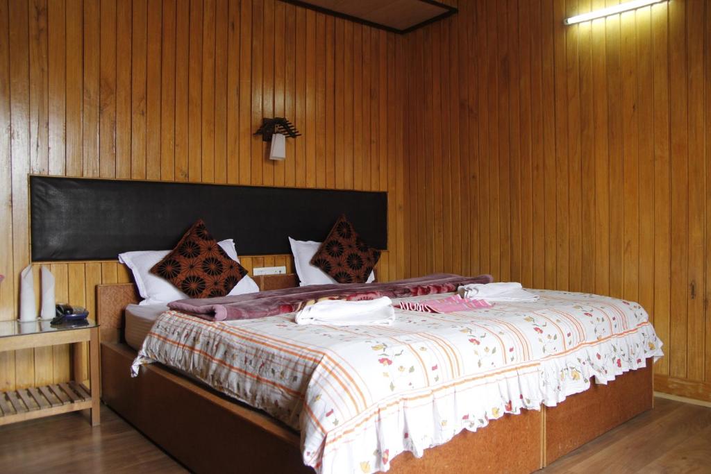 Postel nebo postele na pokoji v ubytování Vamoose Mandarin Village Resort