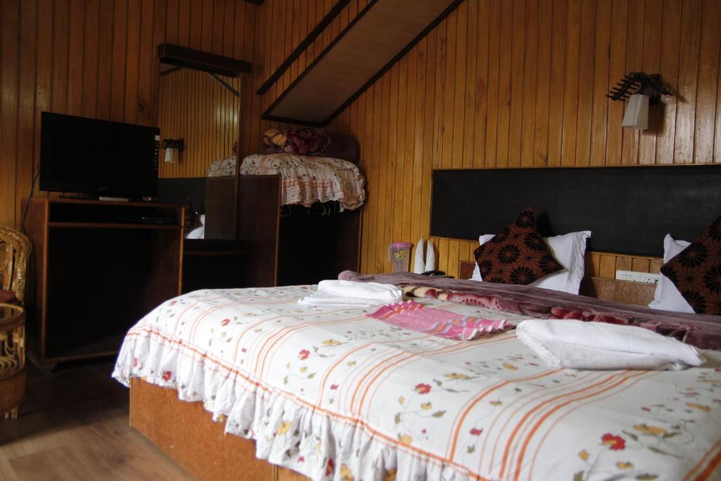 Postel nebo postele na pokoji v ubytování Vamoose Mandarin Village Resort
