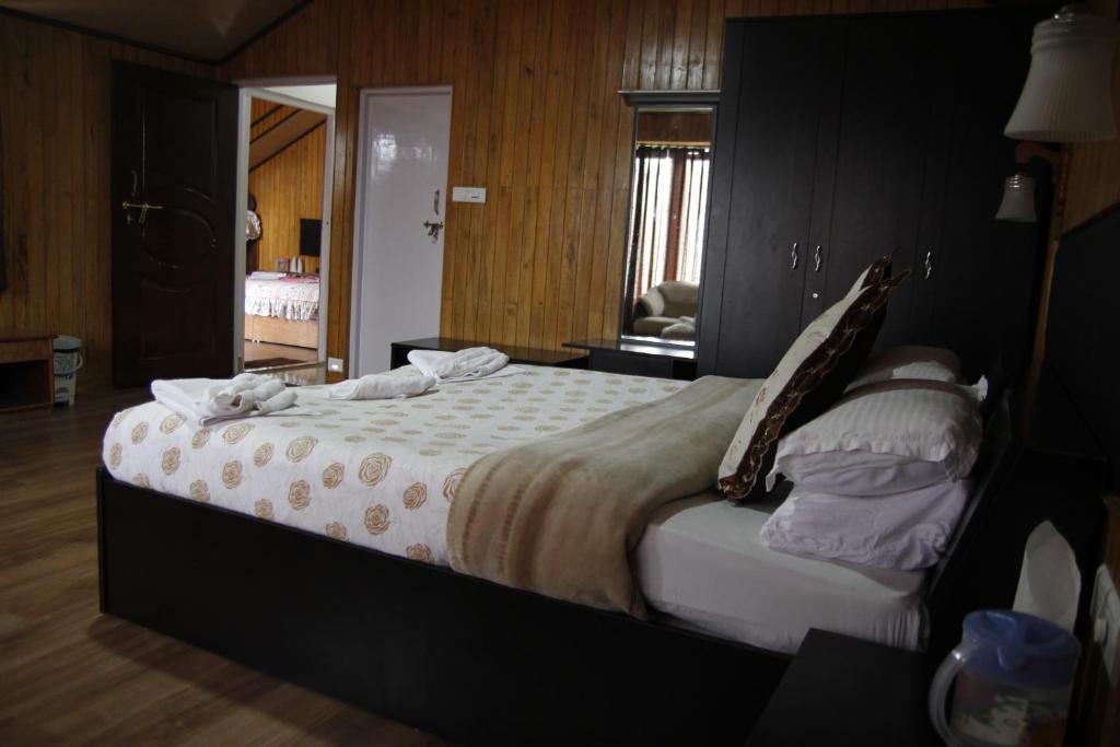 Postel nebo postele na pokoji v ubytování Vamoose Mandarin Village Resort