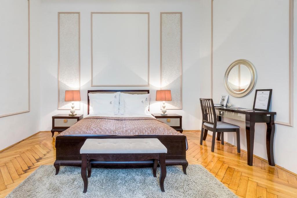 Schlafzimmer mit einem Bett, einem Schreibtisch und einem Spiegel in der Unterkunft Fashion Street Luxury Apartment in Budapest