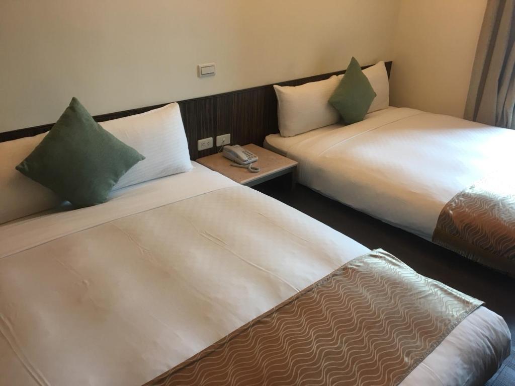 Postel nebo postele na pokoji v ubytování Harmony Ocean Hotel