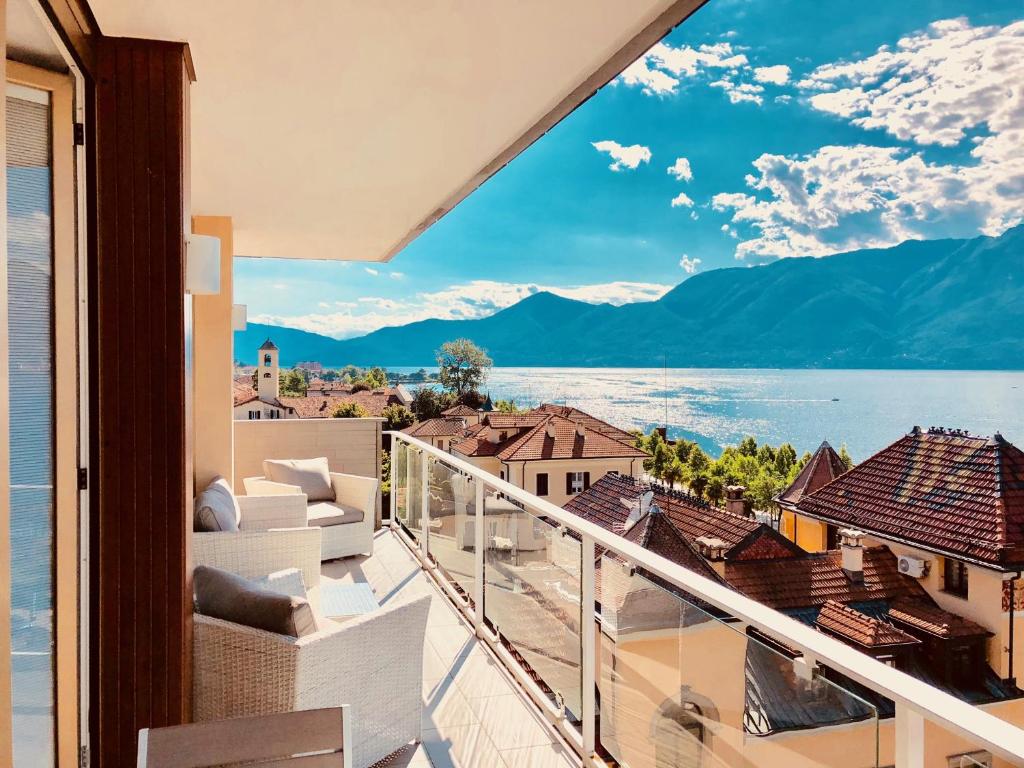 a balcony with a view of the water and mountains at Attico Palazzo di Vetro in Luino