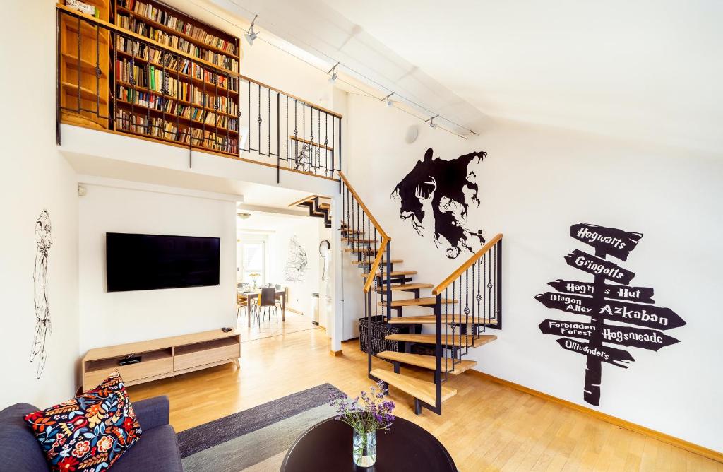 a living room with a staircase and a wall with signs on it at 4BR 3BATH BALCONY central Harry Potter penthouse in Prague