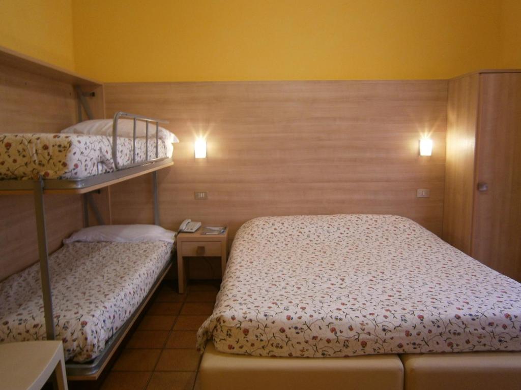 Postel nebo postele na pokoji v ubytování Hotel Chiara