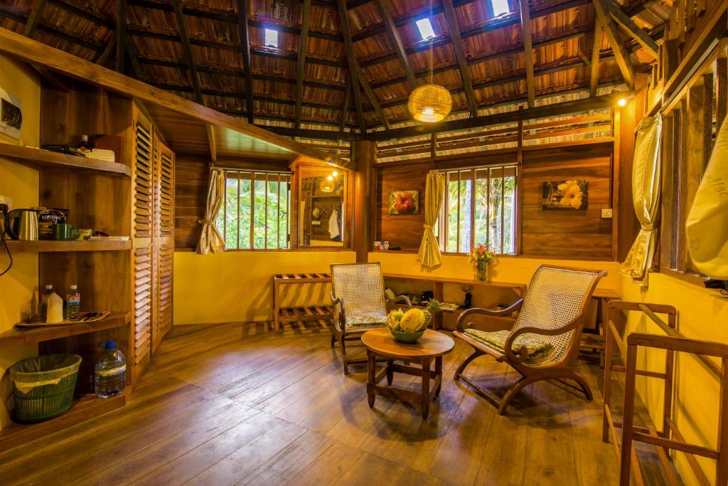 a room with chairs and a table in a house at Palm Paradise Cabanas & Villas Beach Resort in Tangalle