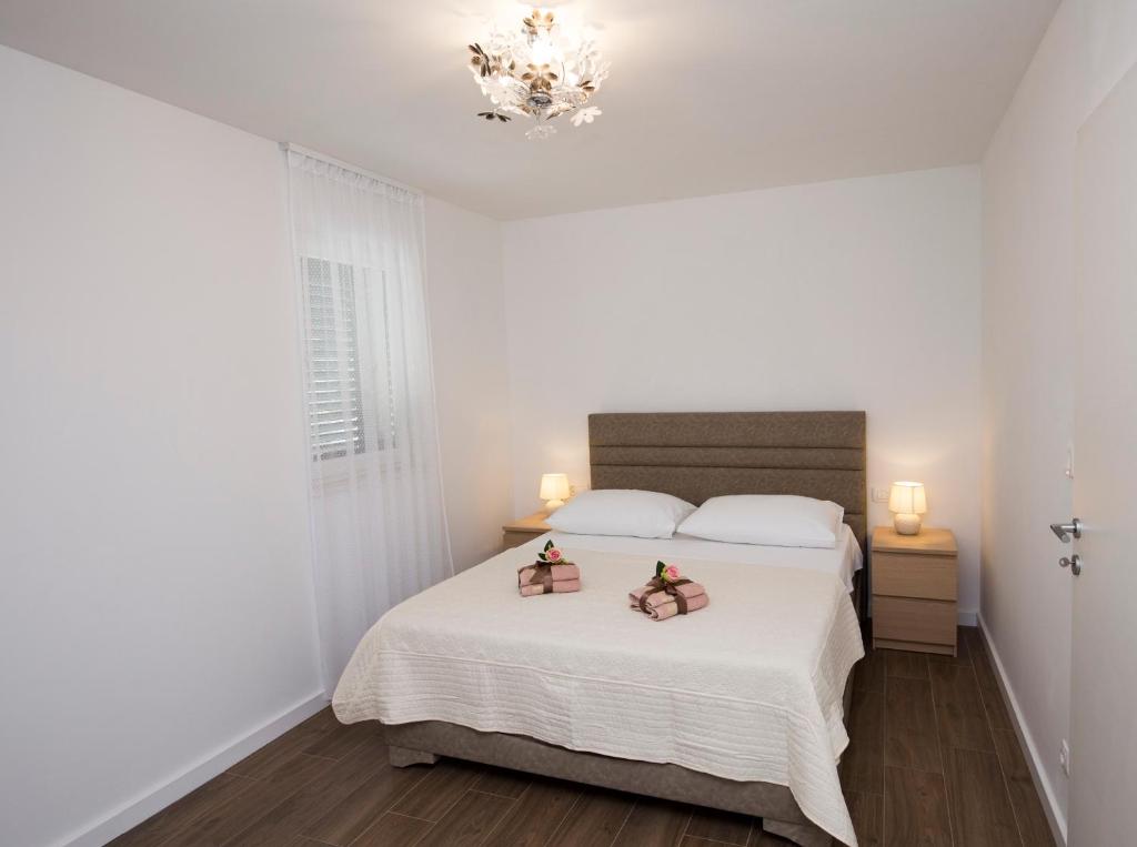 Postel nebo postele na pokoji v ubytování Apartments Lanterna