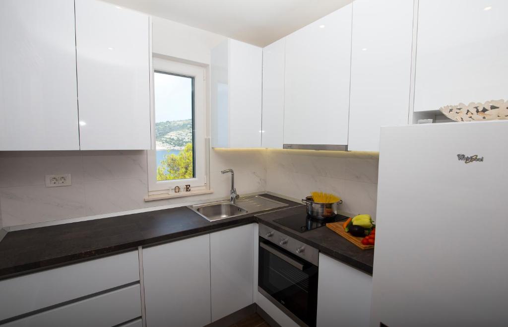 Kuchyň nebo kuchyňský kout v ubytování Apartments Lanterna