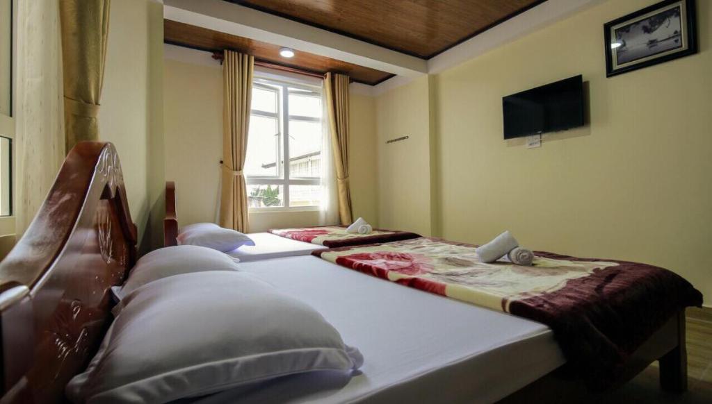 Postel nebo postele na pokoji v ubytování Bình Đào Hotel - Khách sạn ngay trung tâm giá rẻ