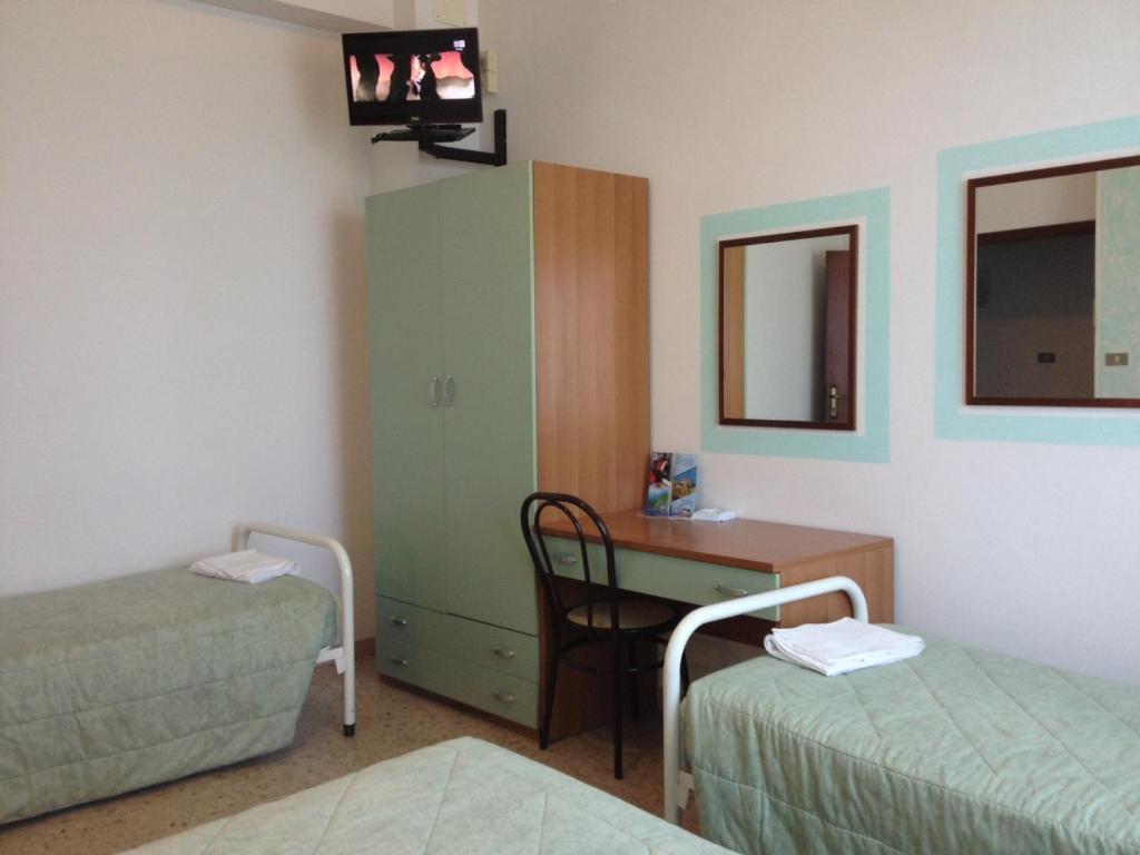 Postel nebo postele na pokoji v ubytování Hotel Rivamare