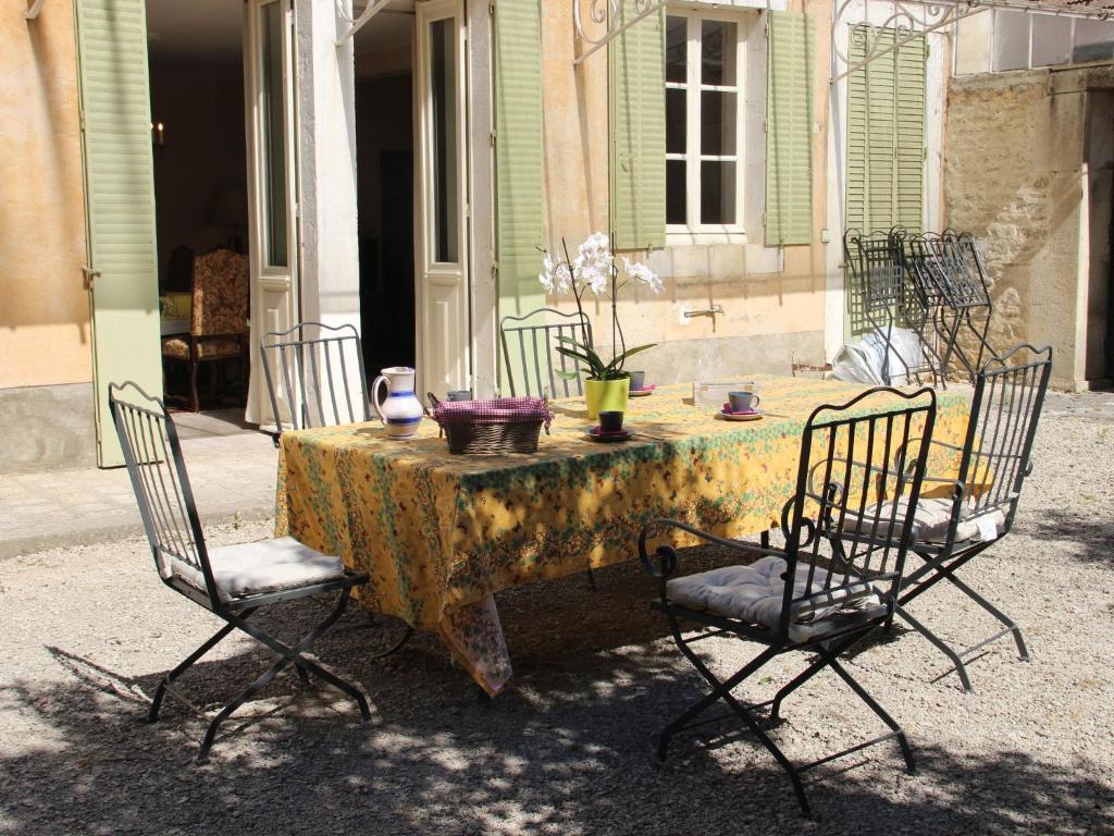 a table with two chairs and a table with a table cloth at Beautiful country house with enclosed garden in green surroundings in Burgundy in Bouix