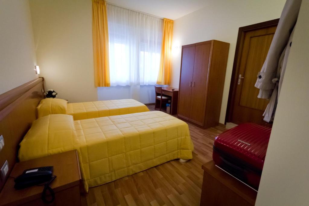 Postel nebo postele na pokoji v ubytování Hotel Donnini