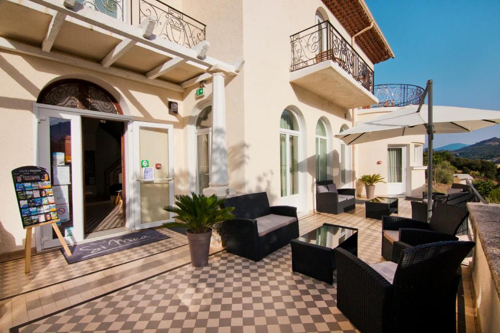 a patio with couches and chairs on a building at Si Mea in Corte