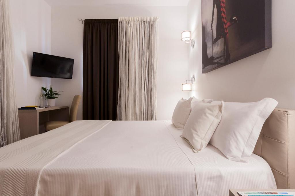 Postel nebo postele na pokoji v ubytování Alexandra Hotel