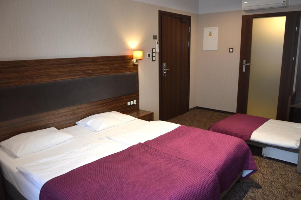 Postel nebo postele na pokoji v ubytování Hotel Silver