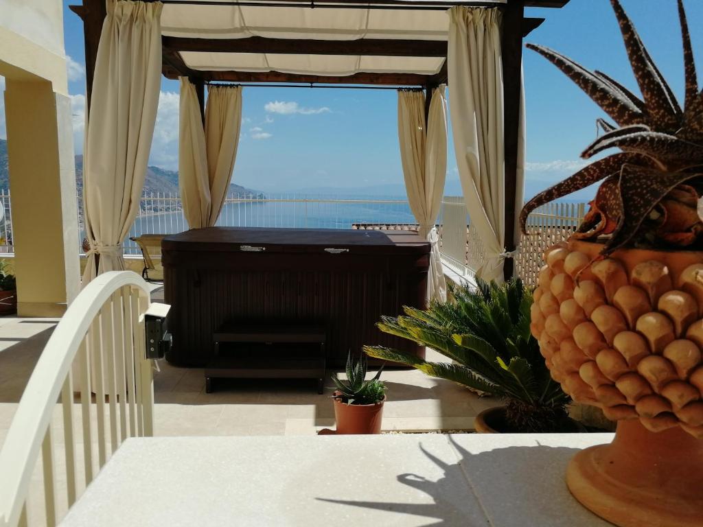 a balcony with a piano and a view of the ocean at Le Villette - Taormina in Taormina
