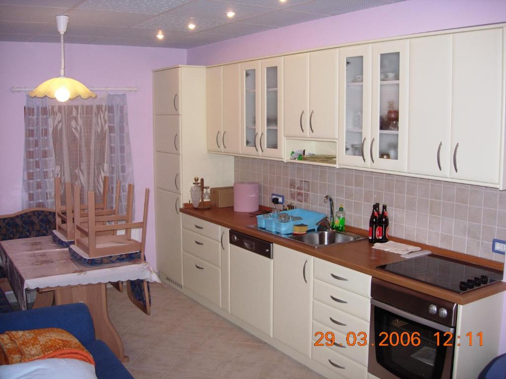 a kitchen with white cabinets and a sink at House of relaxation in Zgornja Sorica