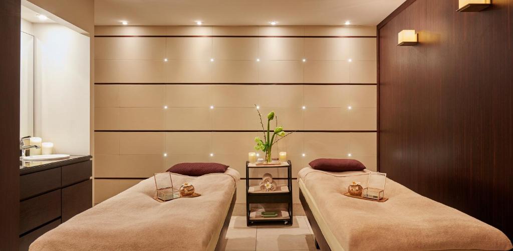 a bathroom with two beds and a sink at Le Burgundy Paris in Paris