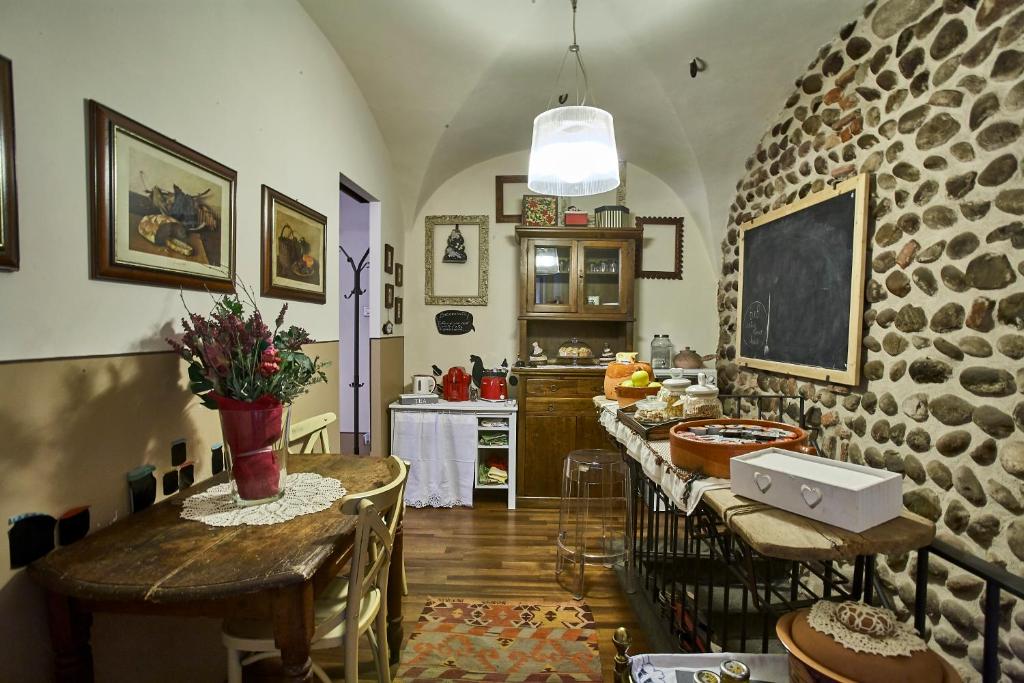 a kitchen with a table and a stone wall at Centro Storico in Chiari