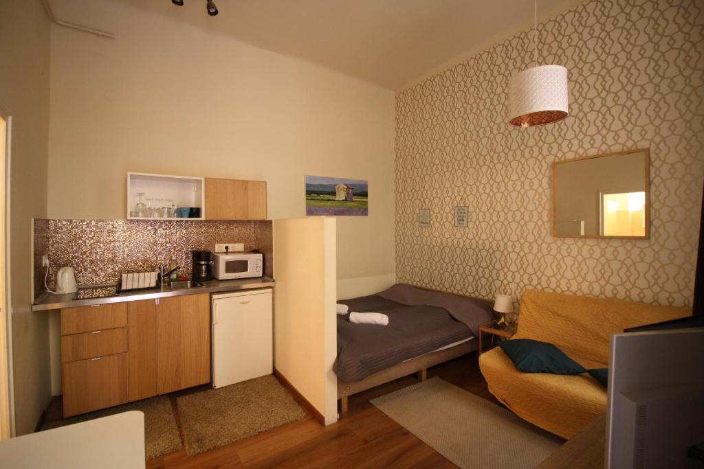 a small room with a small kitchen with a bed at Home Apartment near Blaha Lujza Square in Budapest