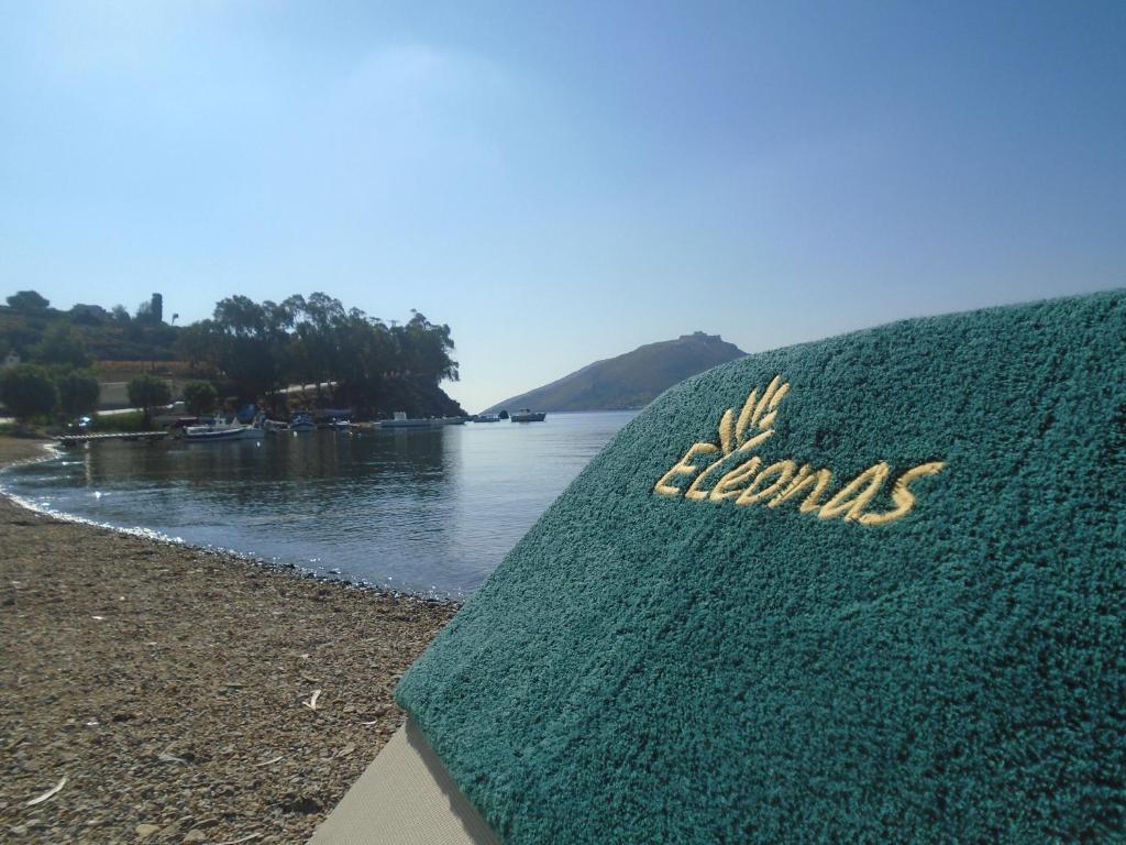 a sign on the shore of a body of water at Leros Eleonas Apartments in Alinda