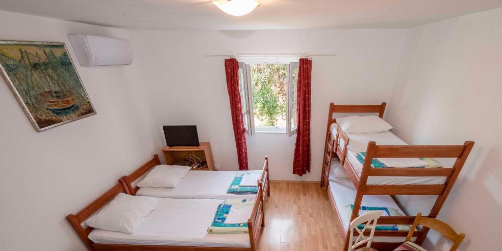 Postel nebo postele na pokoji v ubytování Guesthouse Šime