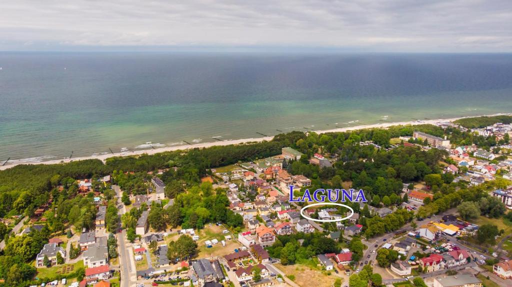 an aerial view of a town next to the beach at Mini Kemping Laguna in Mielno