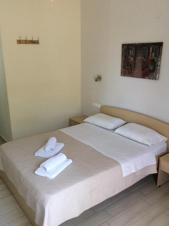 a bedroom with two beds with white towels on them at Elena Rooms in Plakias