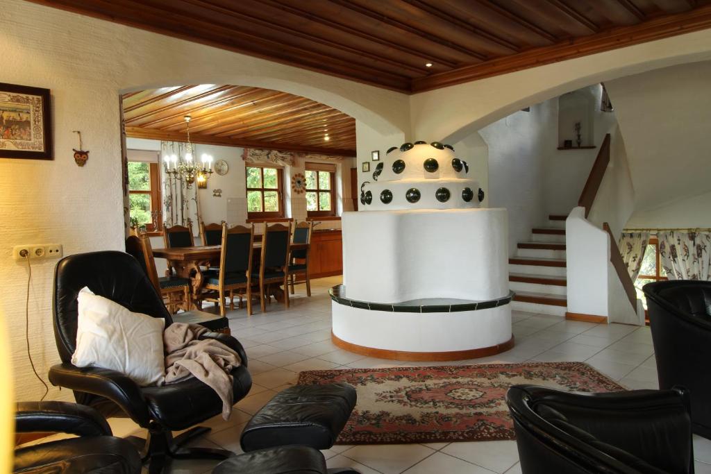 a living room with a staircase and chairs and a table at Haus Franz by ISA AGENTUR in Bad Kleinkirchheim