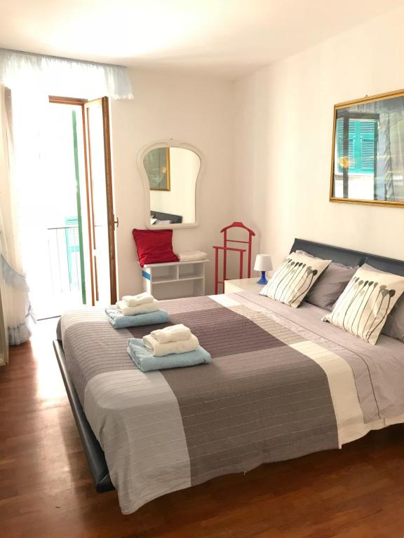 a bedroom with a large bed with towels on it at Casa Alba in Monterosso al Mare