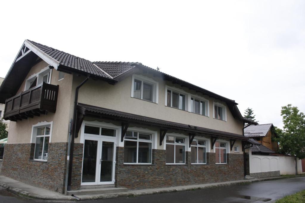 a brick house with a black roof at Casa Ianis in Braşov