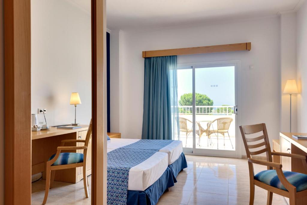 a hotel room with a bed and a balcony at Garden Playanatural - Adults Only in El Rompido