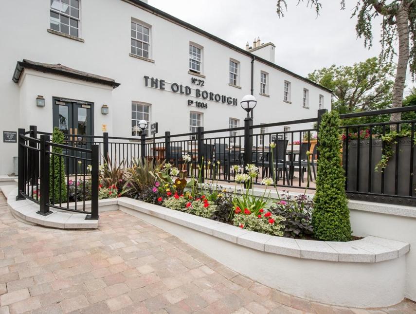 a black fence in front of a white building at The Old Borough Hotel - Wetherspoon in Swords