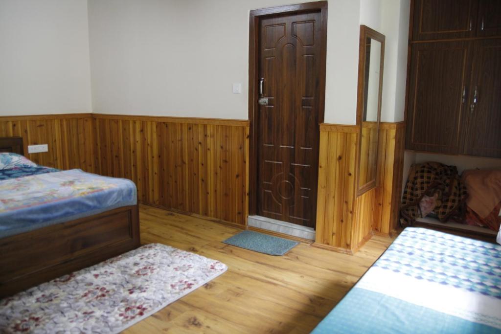 Letto o letti in una camera di Vamoose Gomethang Homestay